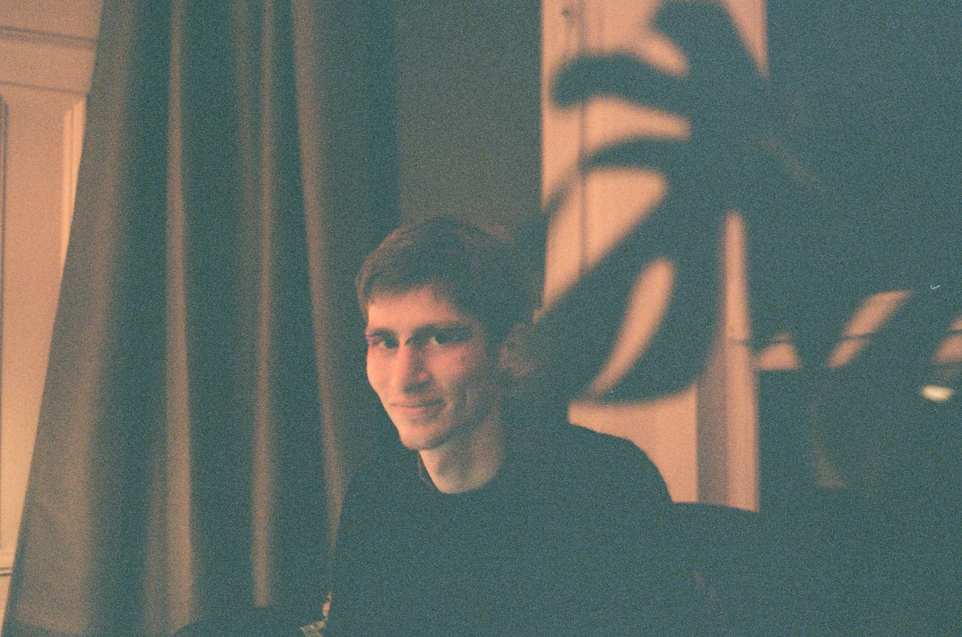 Gabriel next to a swiss cheese plant leaf