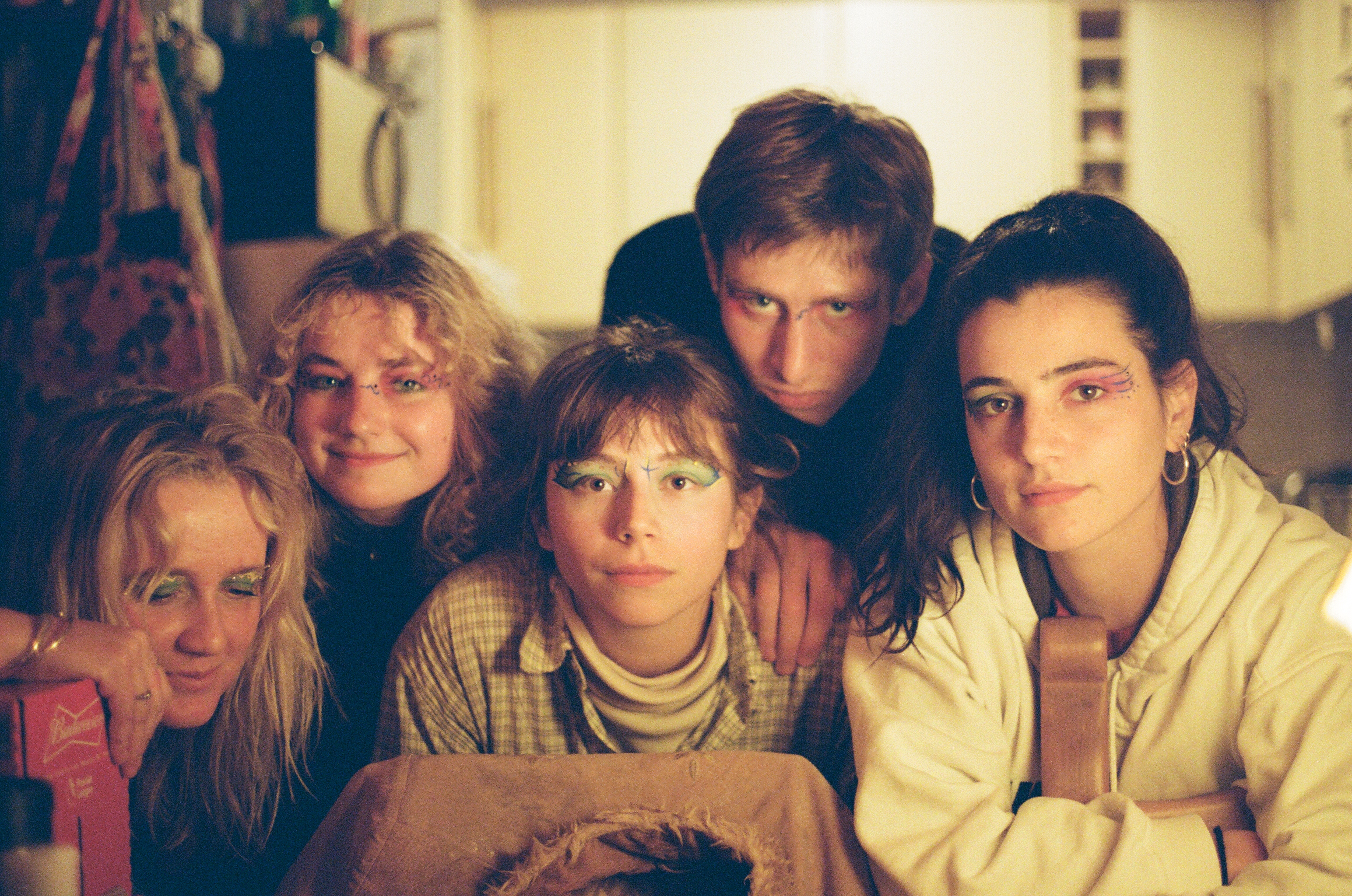 five friends posing wearing fun makeup