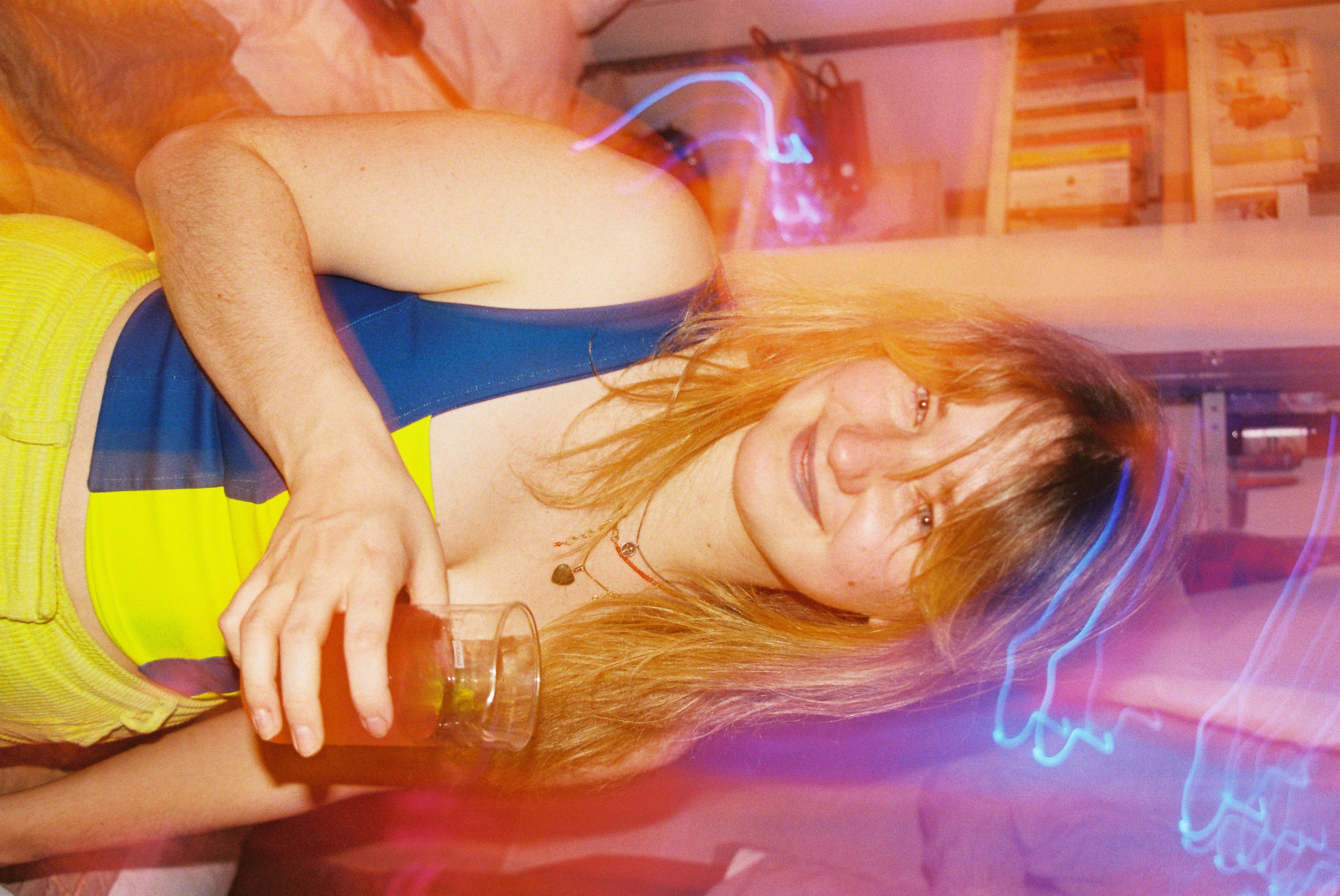 Maria smiling and holding a drink