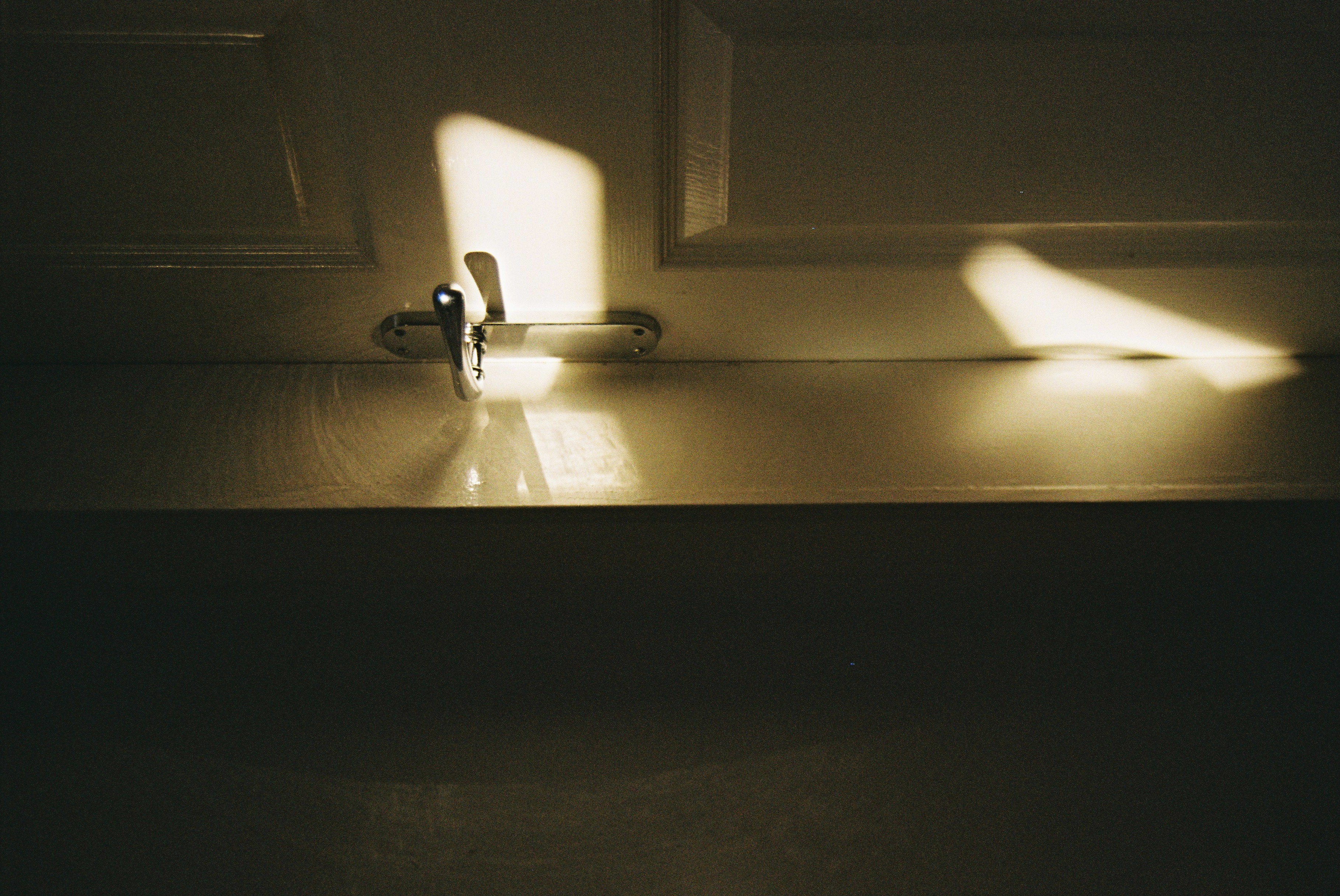 A doorhandle in a sunbeam