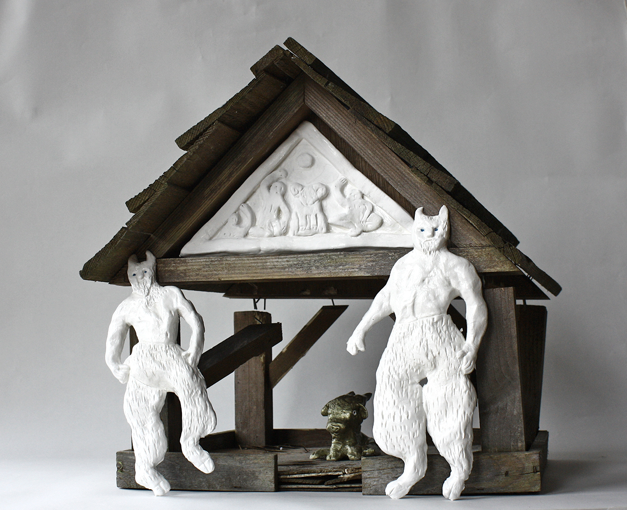 1A broken bird box with air-dry clay pediment guarded by two clay Goatmen.